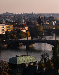 Bridge over river by buildings in city