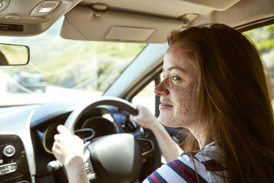 Portrait of woman sitting in car