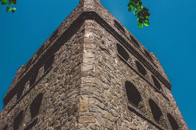 Low angle view of old building against blue sky