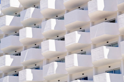 Low angle view of white ceiling apartments with balkony 