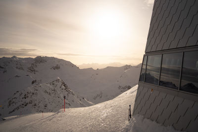 Scenic view of snowcapped mountains against sky during sunset