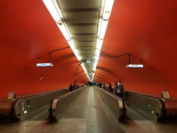 People in illuminated underground walkway