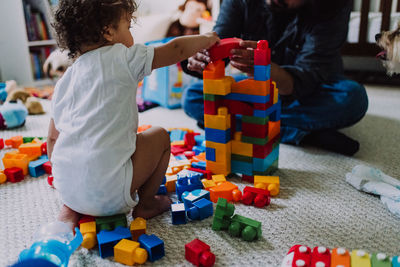 Child and father building block castle