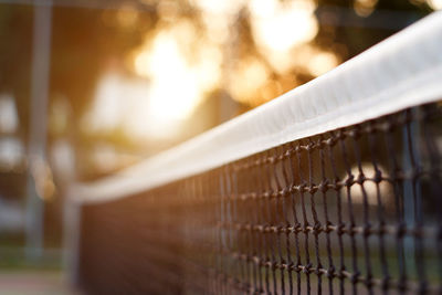 Close-up of metal fence against building