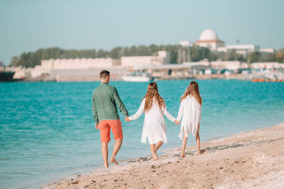 Rear view of women on beach