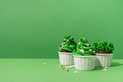 Green fruits against white background