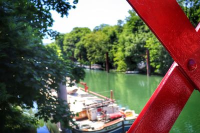 Red boat moored on lake