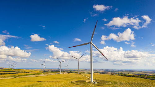 Windmill on field against sky