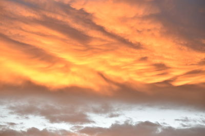 Low angle view of cloudy sky at sunset