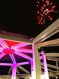 Low angle view of illuminated lights at night