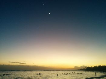 Scenic view of sea against clear sky at sunset