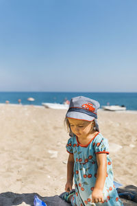 Full length of boy on beach against clear sky