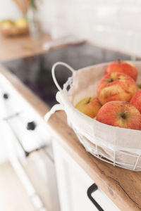 Apples in a basket on white scandinavian kitchen