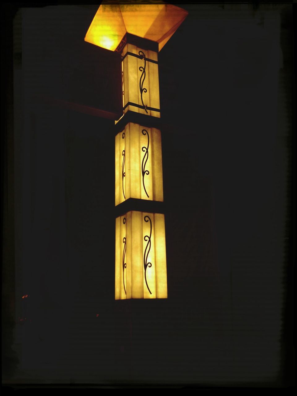 illuminated, transfer print, auto post production filter, lighting equipment, built structure, architecture, indoors, night, door, religion, wall - building feature, yellow, no people, orange color, electricity, text, low angle view, communication, clock, church