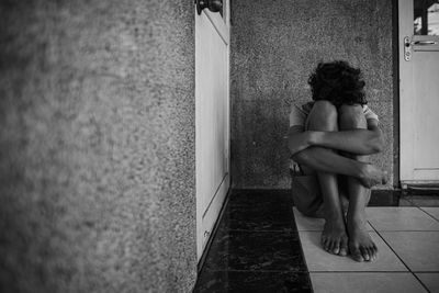 Woman sitting on wall