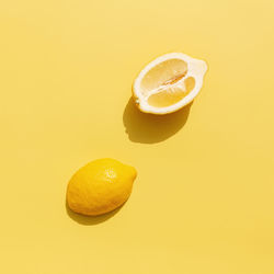 Close-up of lemon slice against orange background