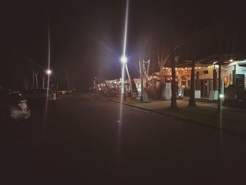 Illuminated city against sky at night