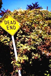 Low angle view of sign board against clear sky