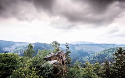 Scenic view of mountains against cloudy sky