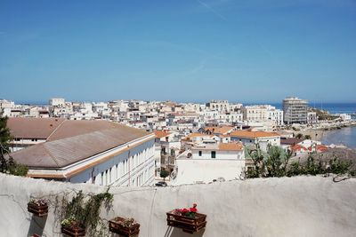 High angle view of townscape against clear blue sky