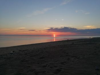 Scenic view of beach against sky during sunset