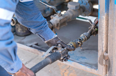 Operator connect vapor pipe from truck tank to gas station.