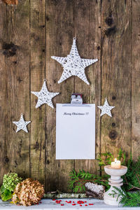 Christmas decorations with clipboard hanging on wooden wall