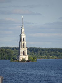 View of building by sea against sky