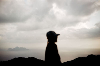 Silhouette woman standing against sky