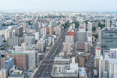 High angle view of modern buildings in city against sky