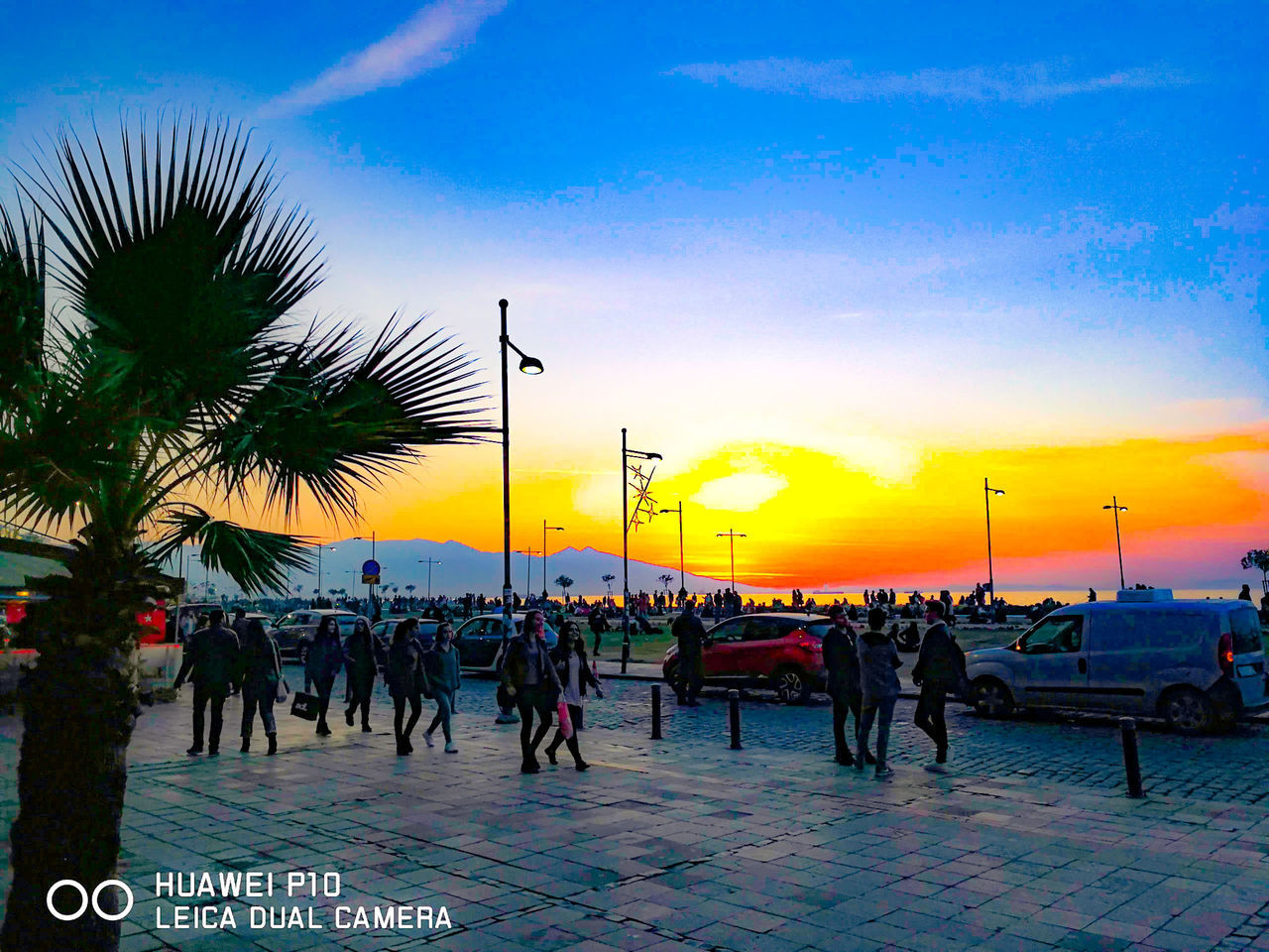 sunset, large group of people, sky, real people, outdoors, cloud - sky, palm tree, travel destinations, nature, men, beauty in nature, tree, city, day, people, adult
