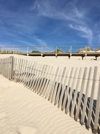 View of dam on beach against blue sky