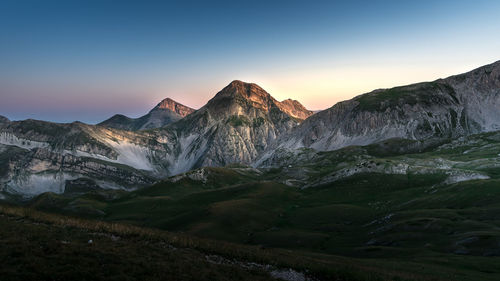 Scenic view of snowcapped mountains against sky during sunset