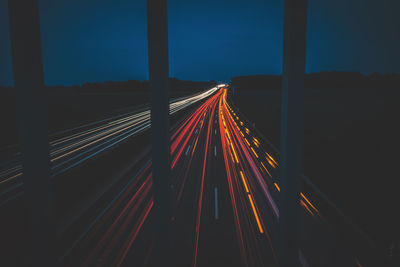 High angle view of light trails on highway at night