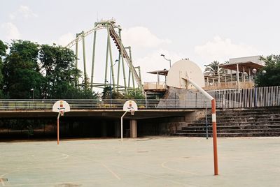 Traditional windmill by building against sky