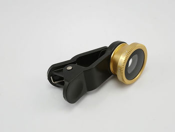 High angle view of camera on table against white background