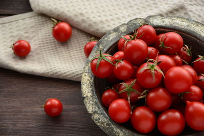 Tomatoes in the basket on the table
