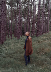 Rear view of man walking in forest