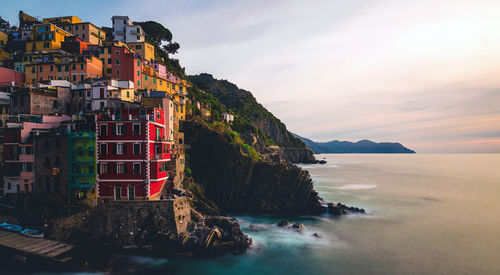 Scenic view of sea and buildings against sky