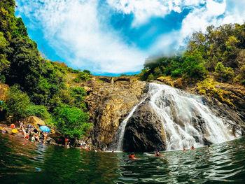 Scenic view of waterfall against sky