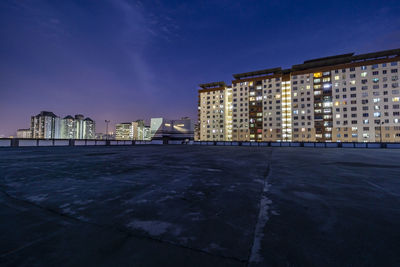 Illuminated buildings against sky at night