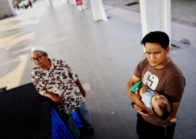 Man with father carrying baby boy