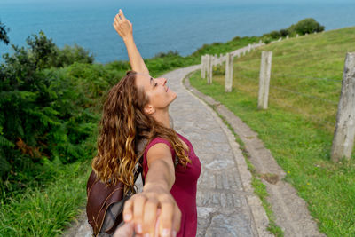 Full length of woman with arms raised