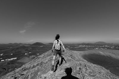 Rear view of woman on a mountain against sky
