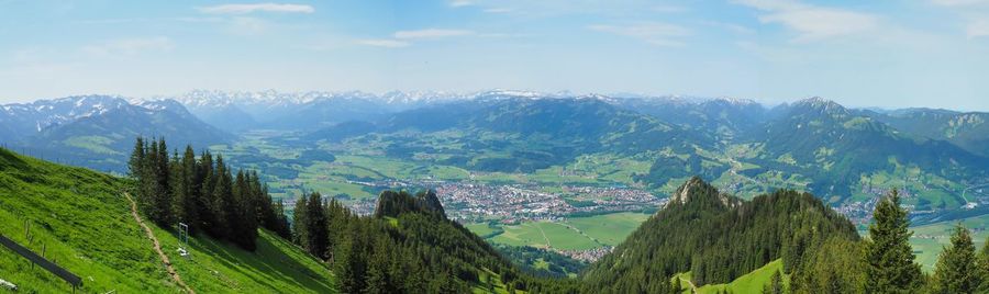 Panoramic view of trees and mountains against sky