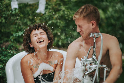 Portrait of a smiling young woman in water