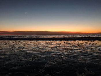 Scenic view of sea against clear sky during sunset