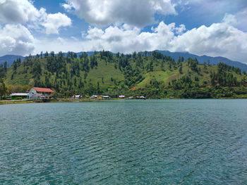 Scenic view of trees and mountains against sky