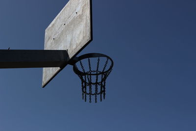 Low angle view of basketball hoop against blue sky