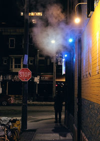 Illuminated road sign at night